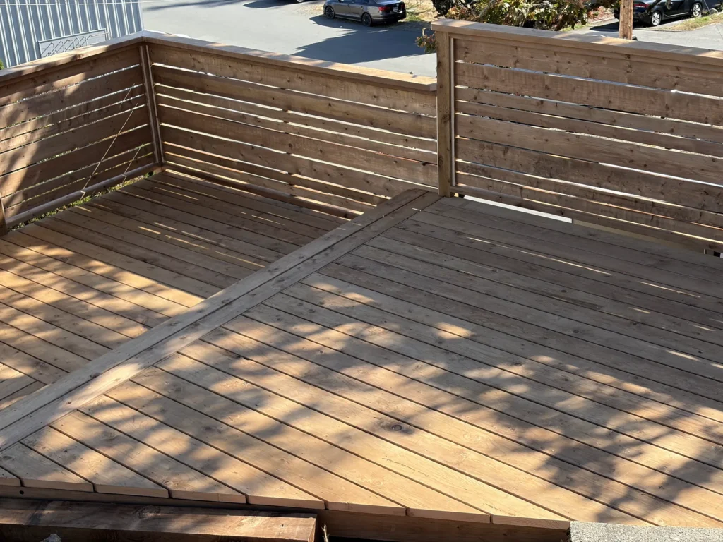 Cedar deck with a horizontal privacy railing built by Leader Construction