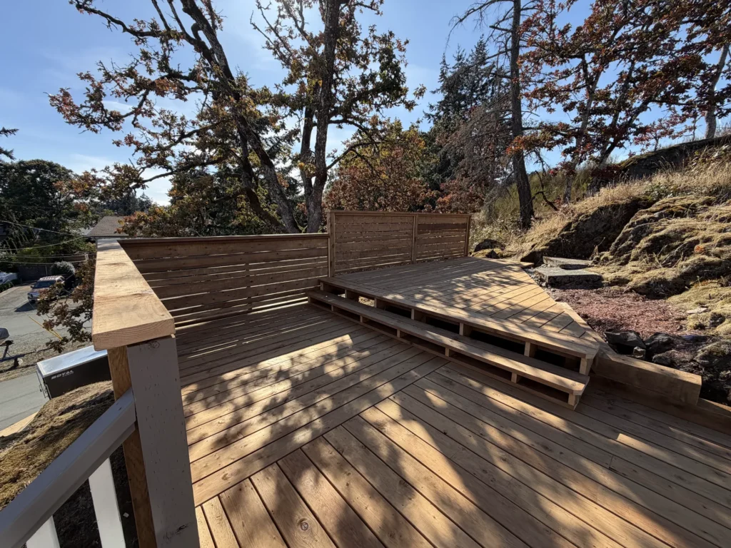 Cedar deck with steps and railing on a rocky lot