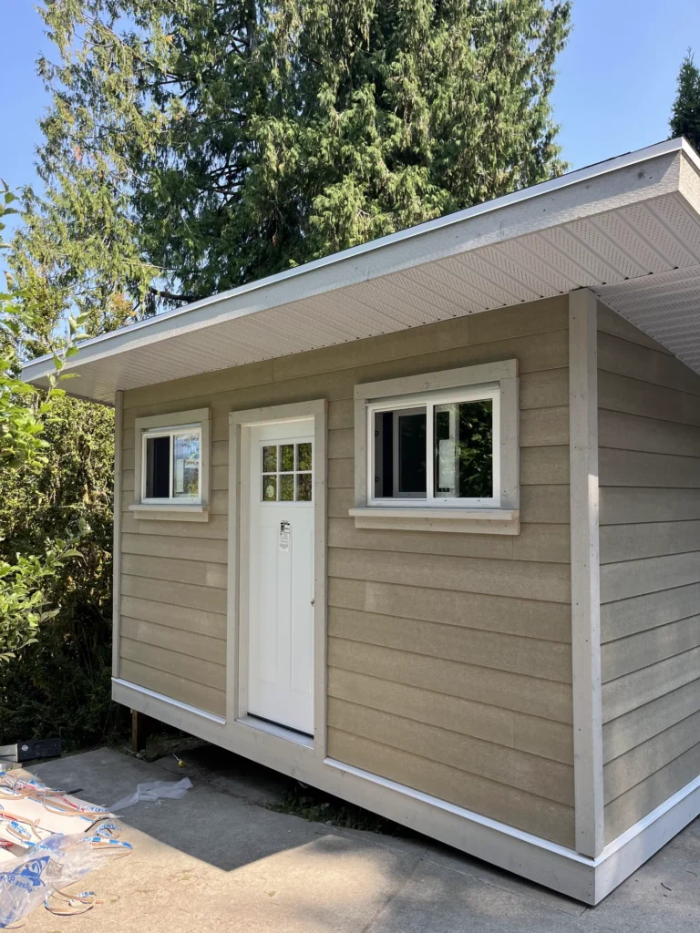 Backyard studio with lap siding and white trim
